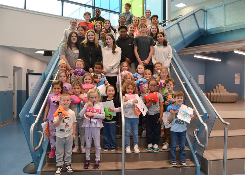 Fred Thomas Middle School eighth-graders gather with Lewes Elementary kindergarten students on monster delivery day.